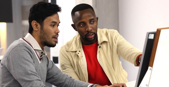 Two students working together at a computer