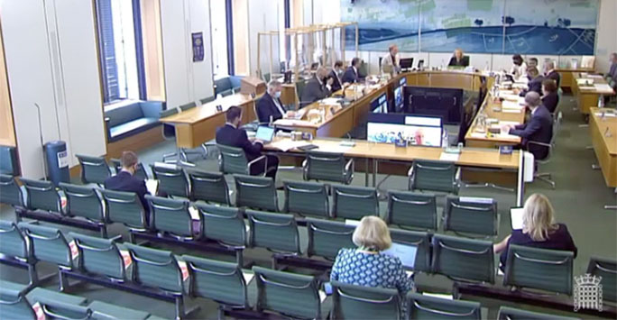 Parliament boardroom with ministers, a 'U' shaped desk and green chairs