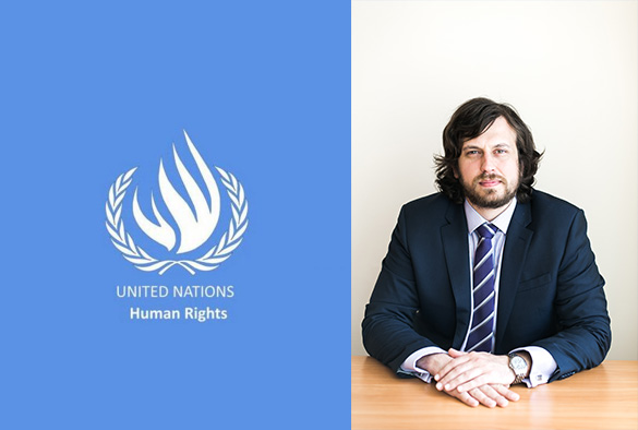 Prof Kanstantsin Dzehtsiarou sitting at a desk in a suit. Half of the picture is a UN Human Rights logo (white on a blue background)
