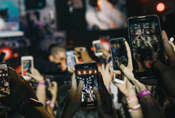 A crowd of people with phones in the air