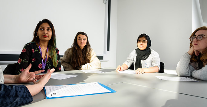 Students working around a table