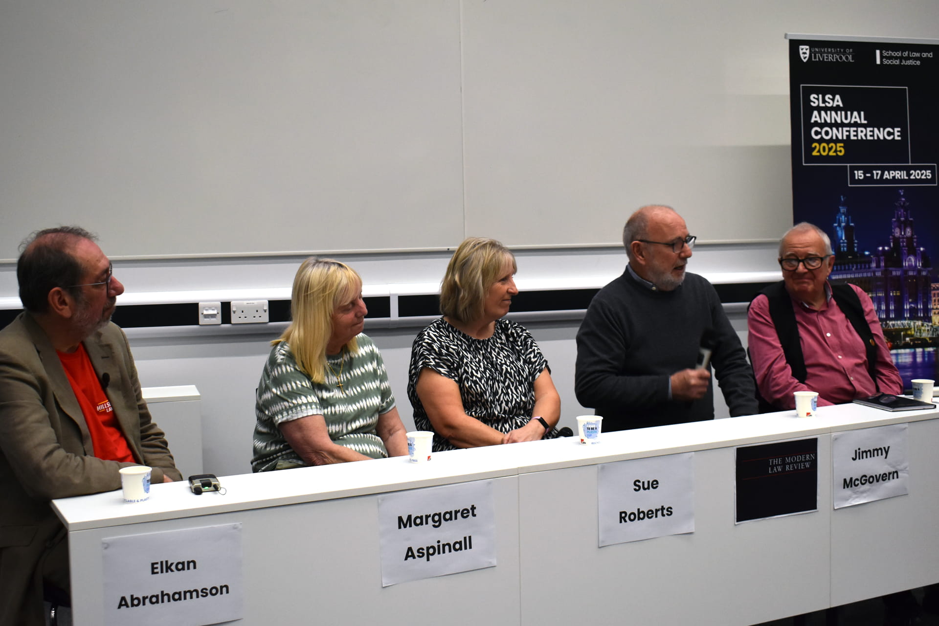 A panel of five speakers.