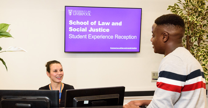 Student at the SLSJ student support desk speaking to a member of staff