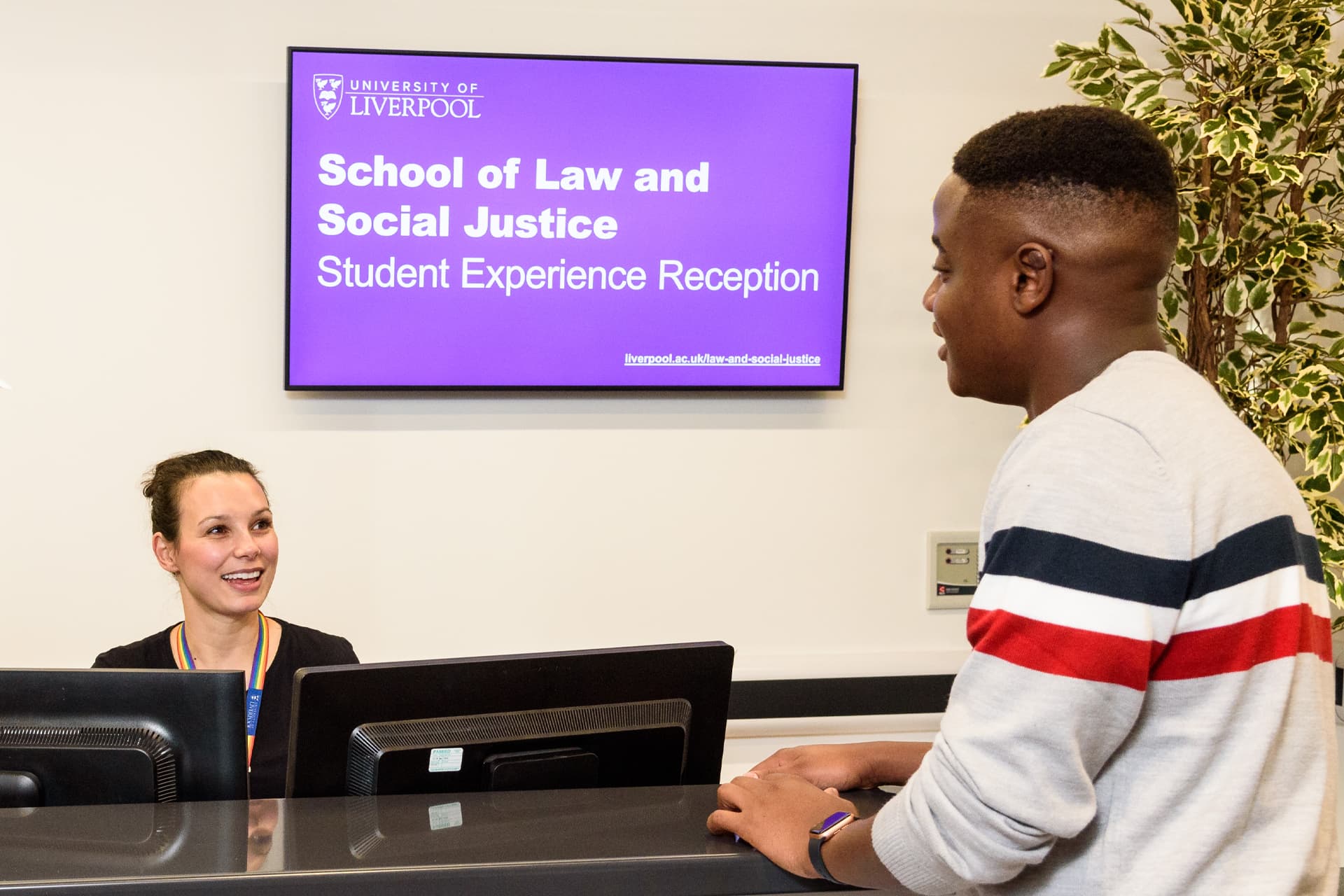 Student at the SLSJ student support desk speaking to a member of staff.