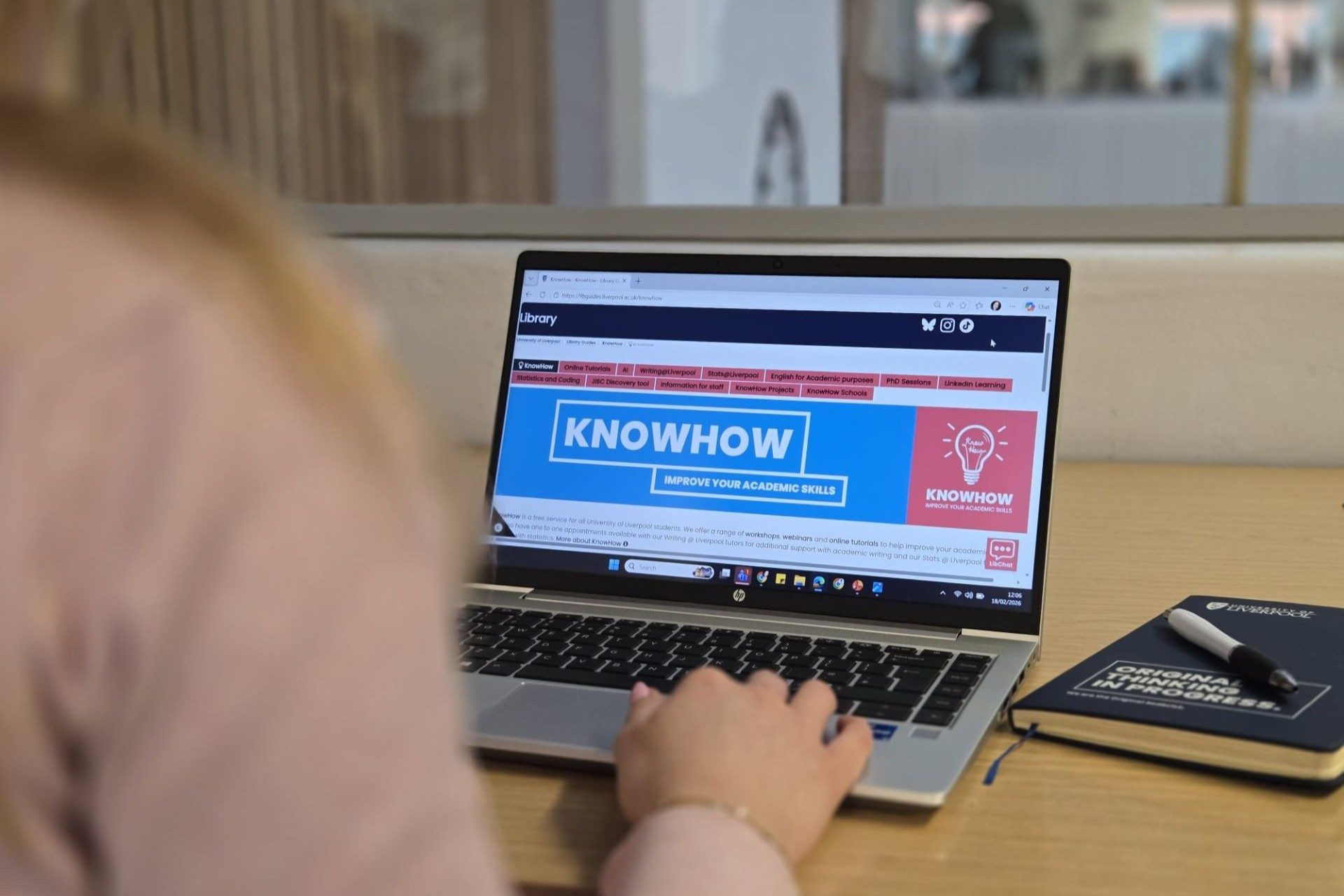 A student searching on a laptop for KnowHow
