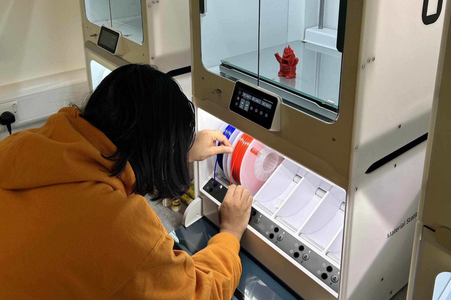 A student using the 3D printer in the Maker Space