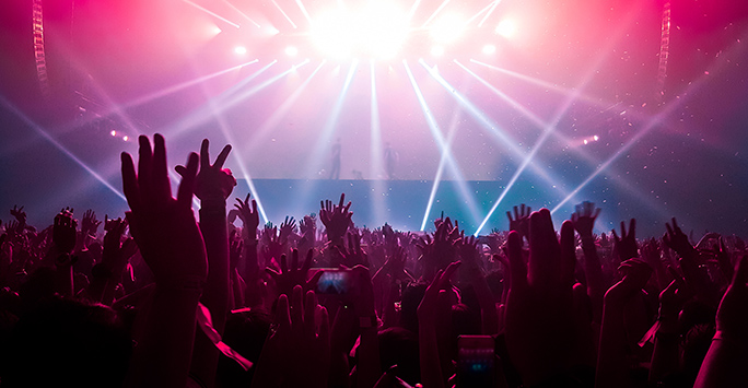 People dancing to live music with hands in the air