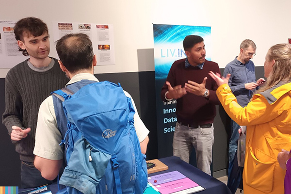 Students during an outreach event, explaining research to general public.