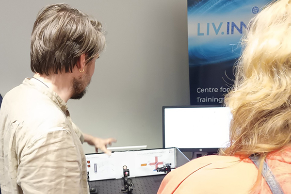 A person explaining a machine to another person.