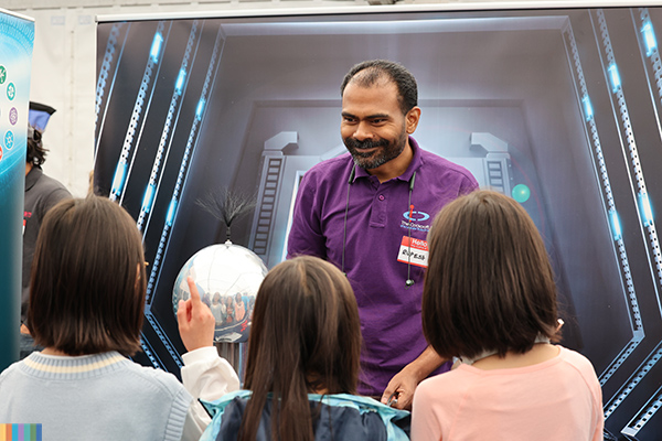 A student explaining something to school children.