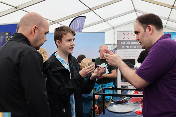 A student explaining something to visitors.