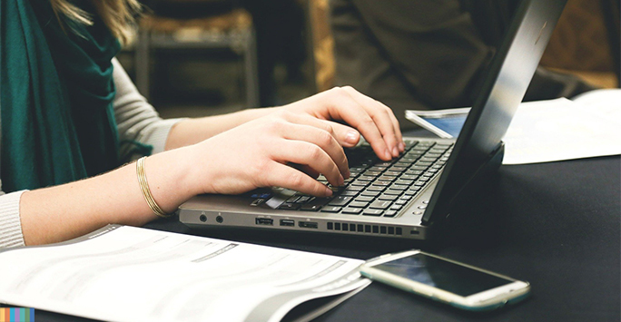 person typing on keyboard