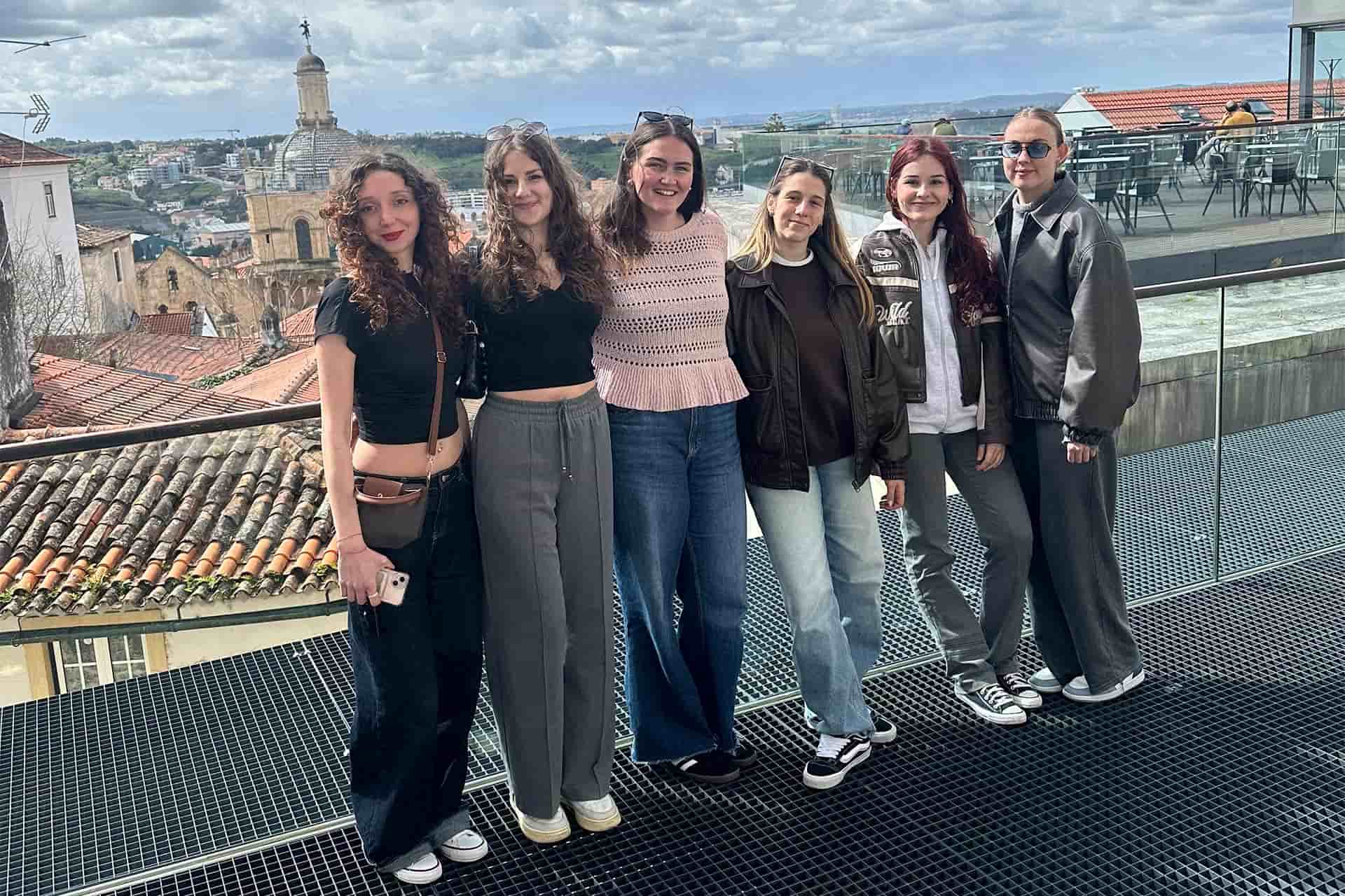 A group of young women standing together outside a european city
