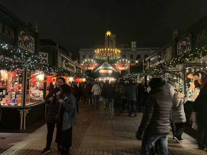 the interior of  traditional German Christmas market at night, including food stalls