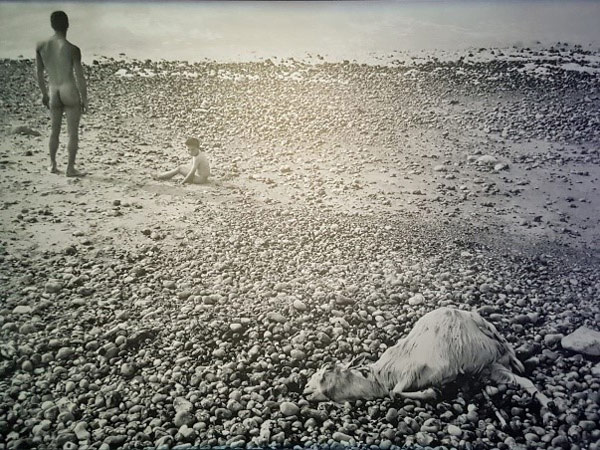 Black and white photo of people on a beach