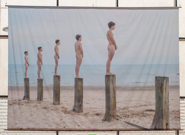Five naked people on a beach