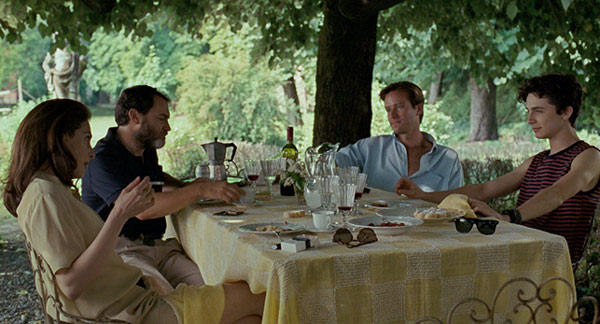 A group of men and a woman having dinner