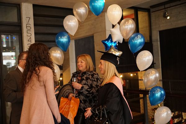 Students and tutors at the balloon archway