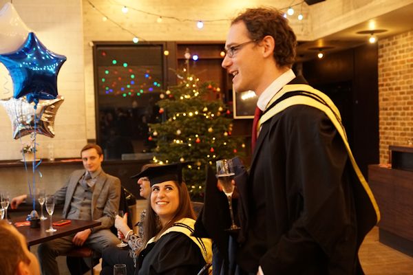 Students drinking bubbly at a reception event.