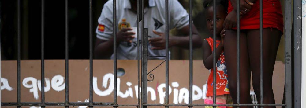 Young girl behind a gate