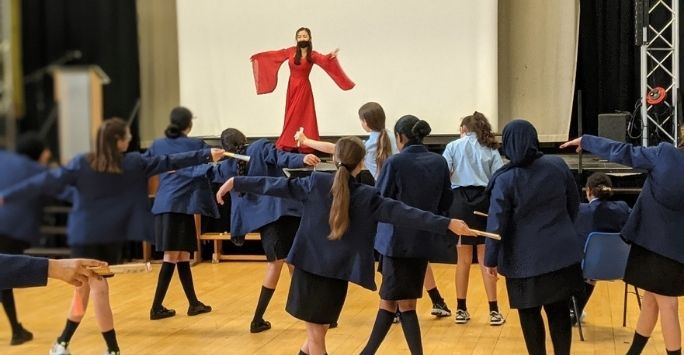 Photograph of students learning a Chinese dance.