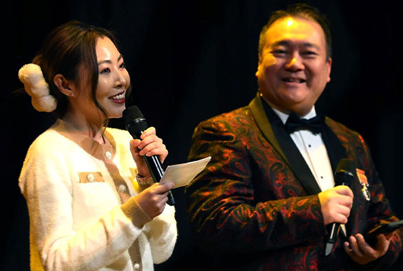Presenters Billy Hui and Yuqiao (Rayna) Cai introduce the gala to the audience