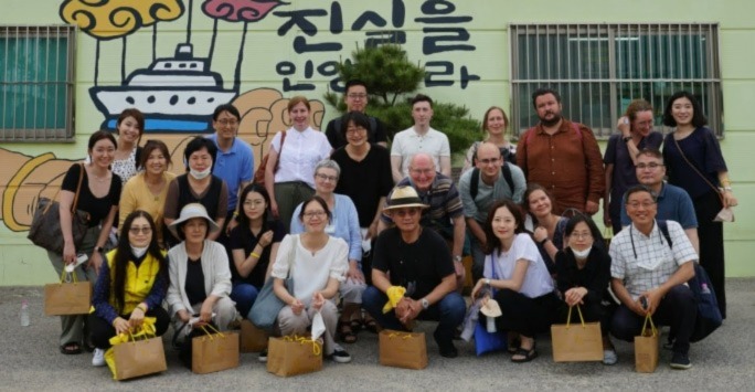 group picture of workshop participants outside of Assembly hall of Sewol families for truth and safer society, Seoul