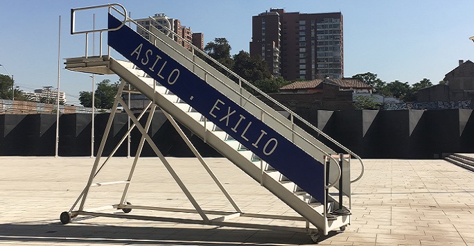portable staircase in a sunny square with asilo, exhilo written on the side