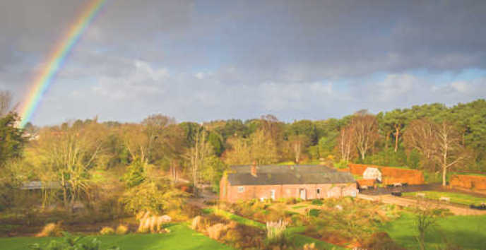 Ness Gardens lawn and potting sheds with a rainbow