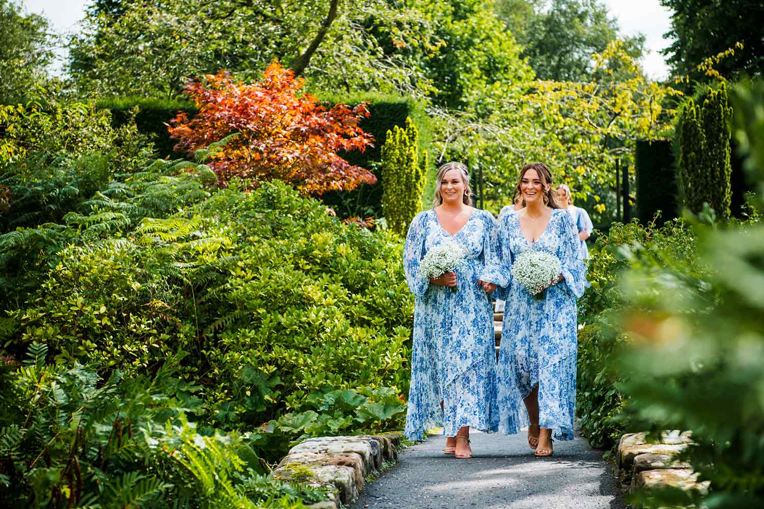 Guests walk through the gardens, on their way to a Rock Garden wedding ceremony.