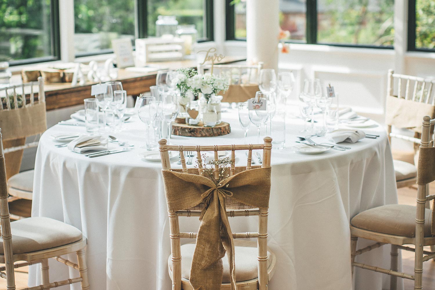 Close-up of a table set out for a wedding reception in the Hulme Conservatory.