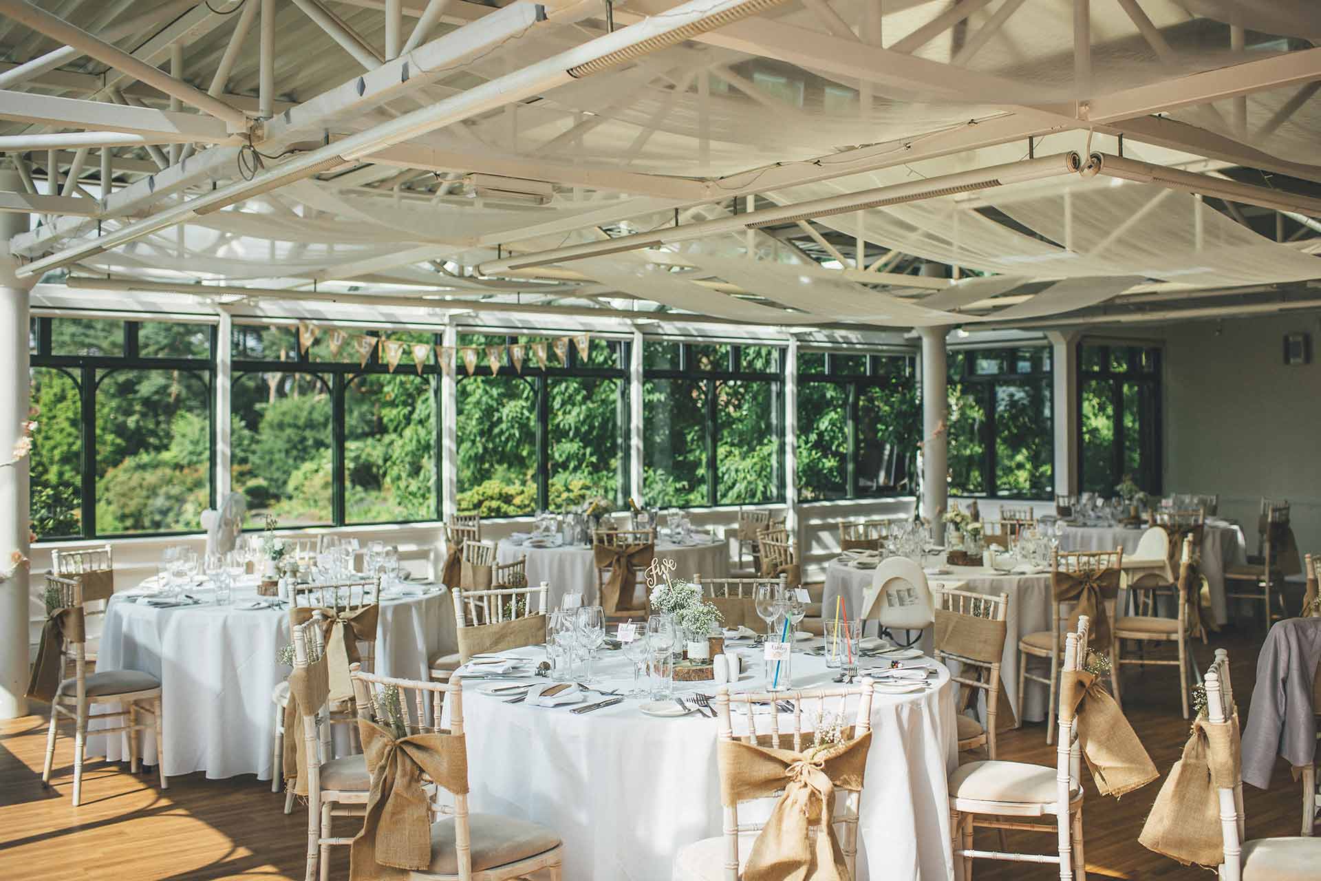 Tables set our for a wedding breakfast in the Hulme Conservatory.