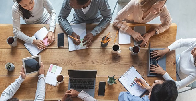 Overhead shot of a team collaborating around a table