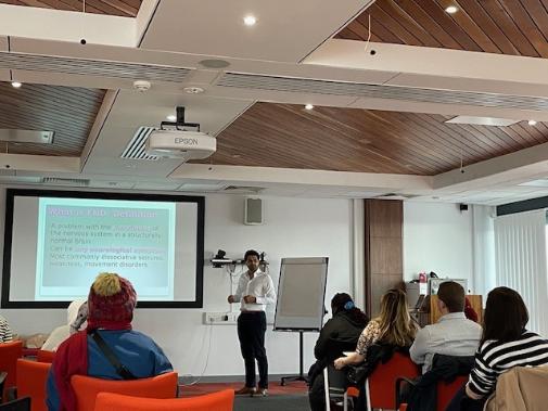 Participants at a NeuroPRACTICE course listening to a talk