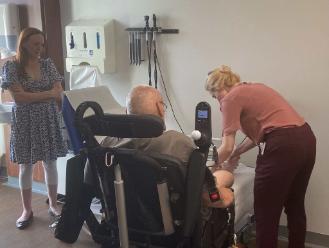 Patient's lower limbs being clinically examined by junior doctor at NeuroPACES course