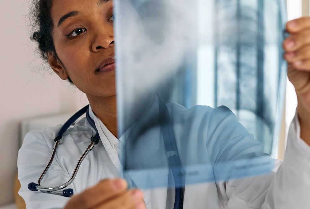 Person holding a lung x-ray.