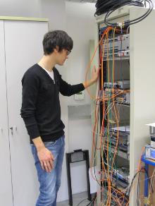 Trainee Manuel Cargnelutti checks the cable connections and the state of the Beam Position Monitors under the testing procedure
