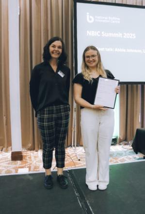 Abbie Johnson being awarded best presentation prize certificate