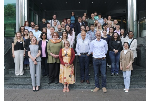 OPIHAS team standing together on steps at the NBIC summit and Biofilms conference