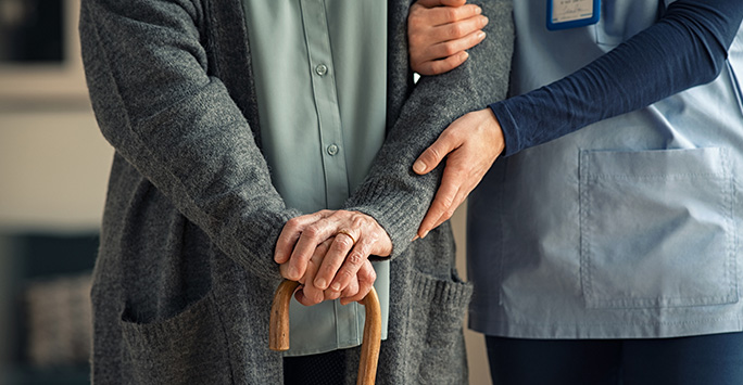 Nurse helping elderly patient to walk