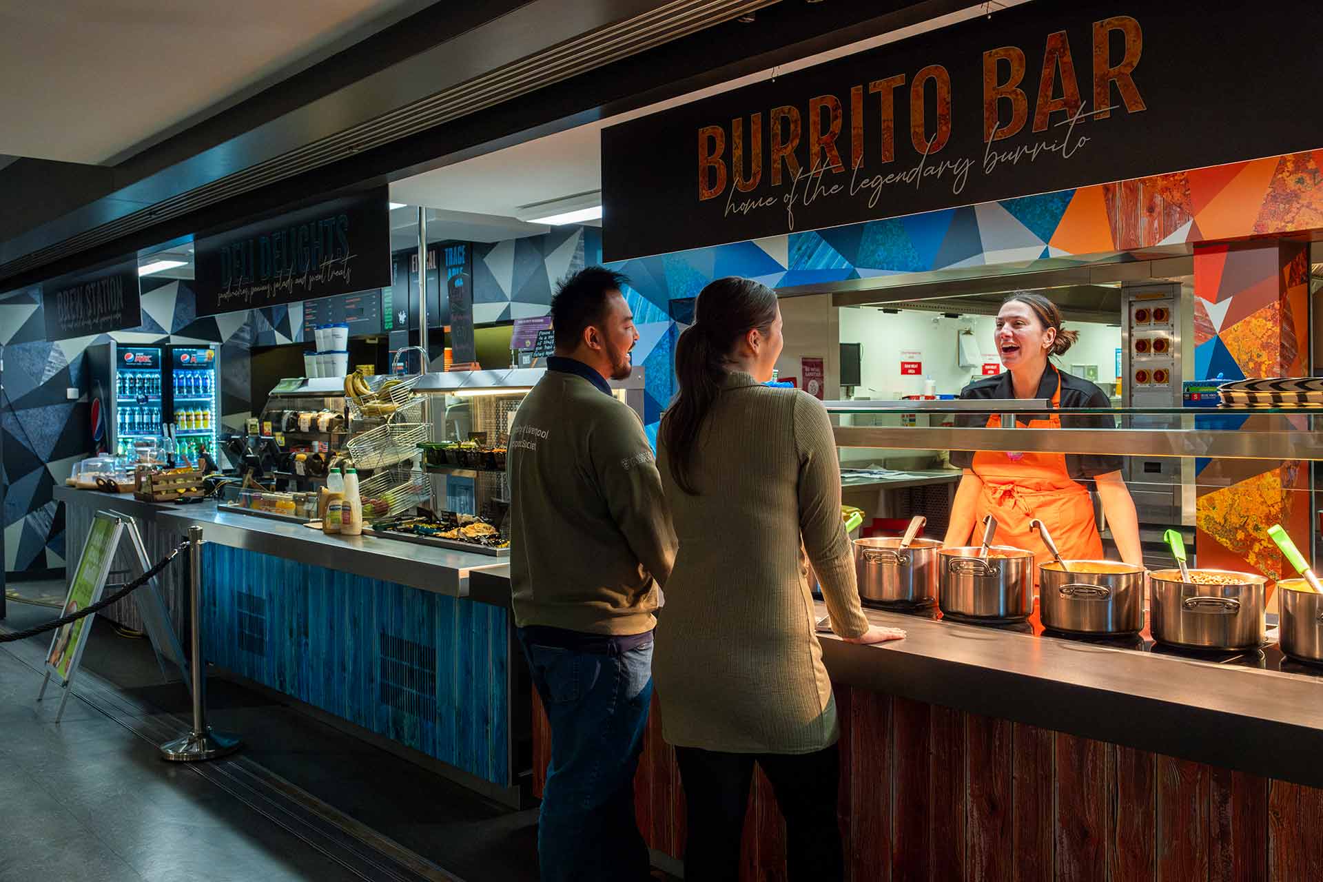 Two students at the burrito bar in the Guild.