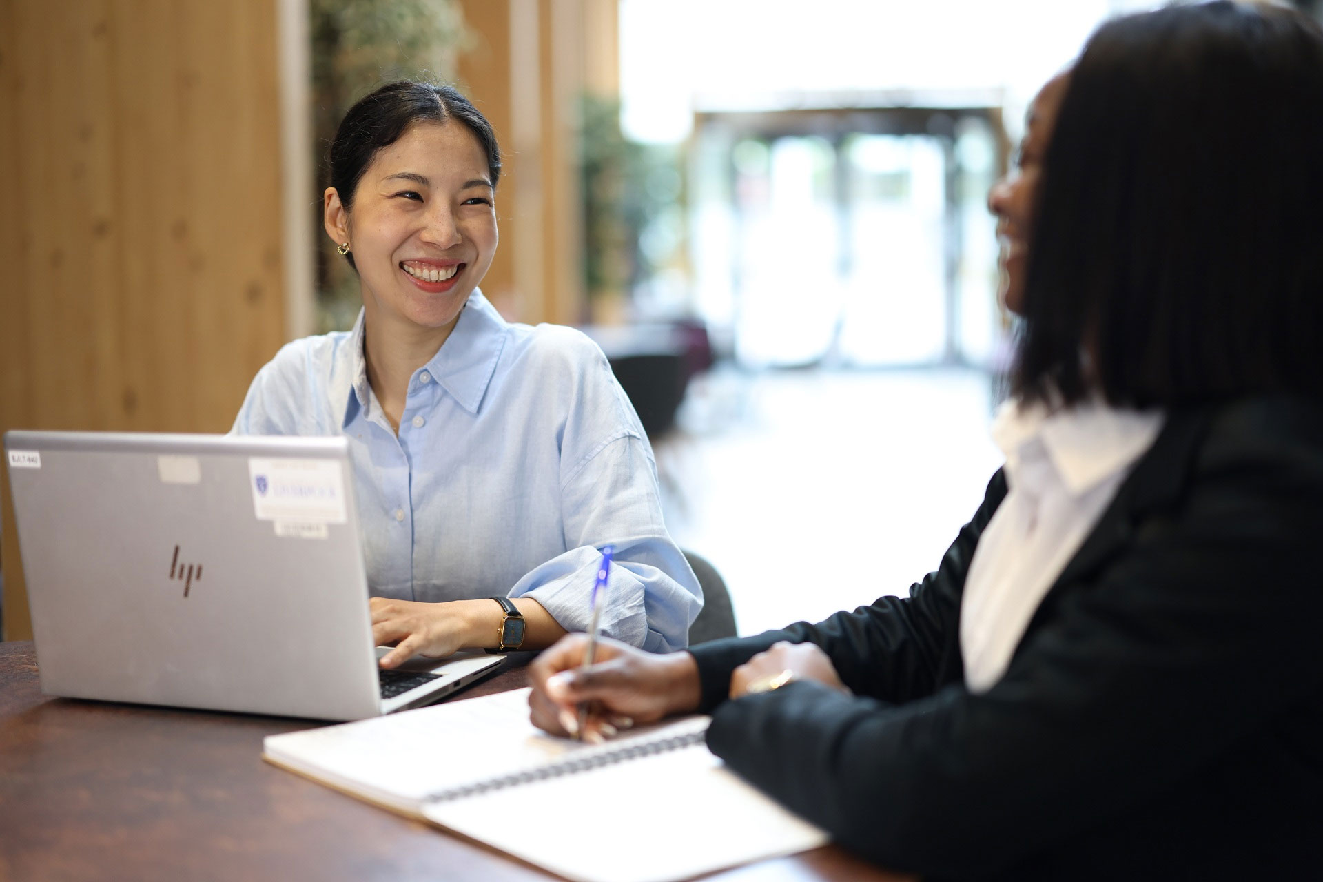 Postgraduate students, Anastacia Ezeh and June Seo, working a laptops
