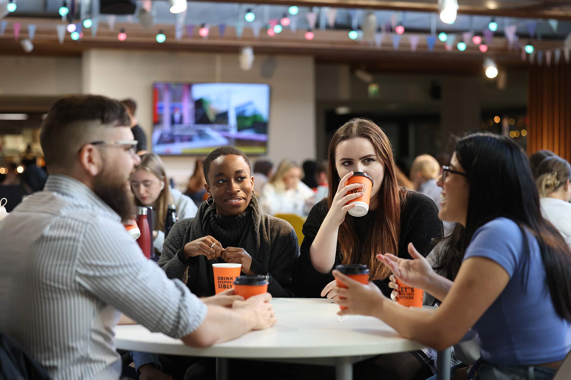 A group of students sitting around a table drinking coffee in the Liverpool guild of Students