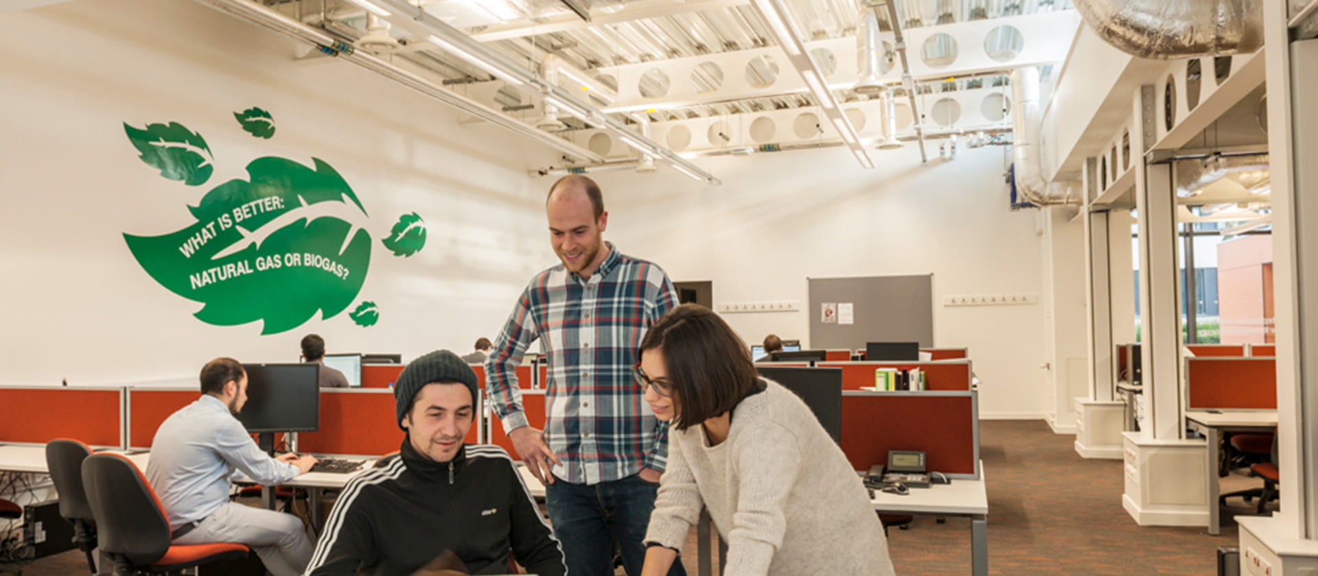 Group of researchers looking at a laptop