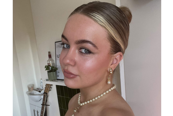 elle-may-keenan wearing a pearl necklace and matching earrings, showcasing elegant jewelry against a neutral background
