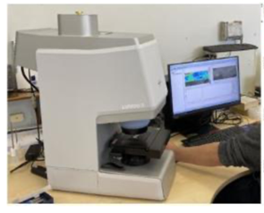 a computer screen through a microscope, focusing on detailed images displayed on the screen.