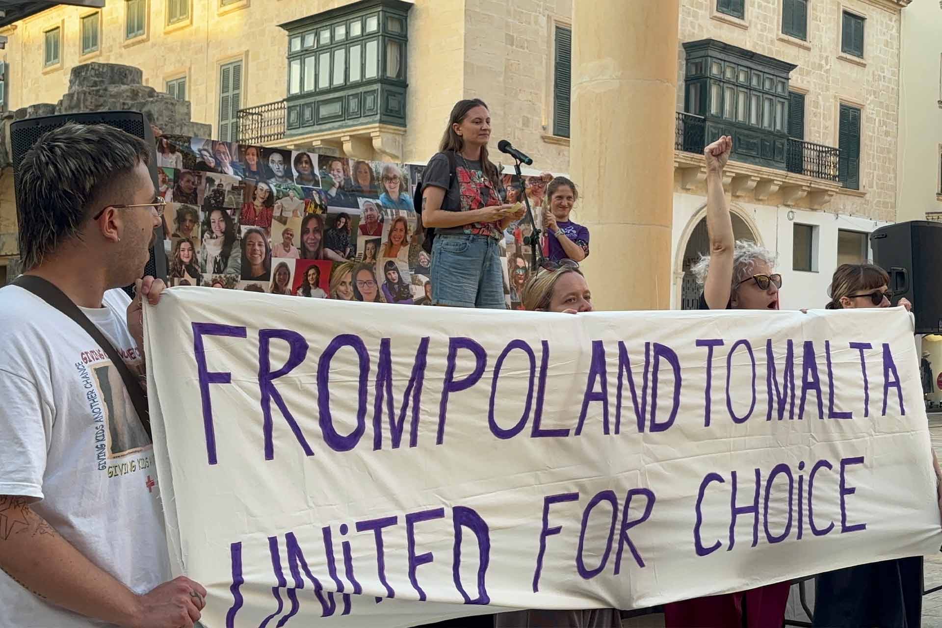 People protesting holding a handwritten sign reading: From Poland to Malta, united for choice