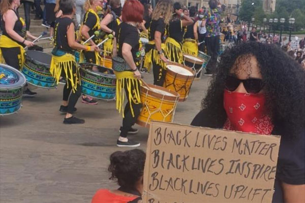 Woman with banner at Black Lives Matter protest