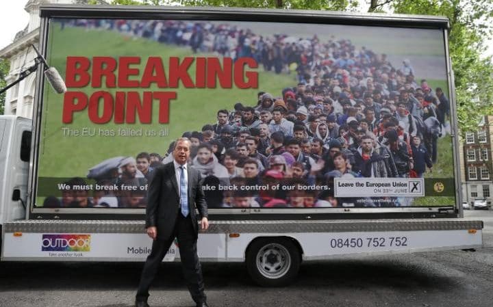 Nigel Farage in front of UKIP's 'Breaking point' poster.