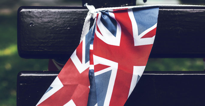 A Union Jack flag draped over a bench